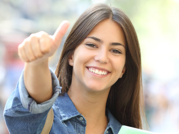 Young woman giving a thumbs-up signal