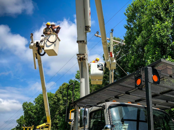 Men working on electrical wires for a utility company