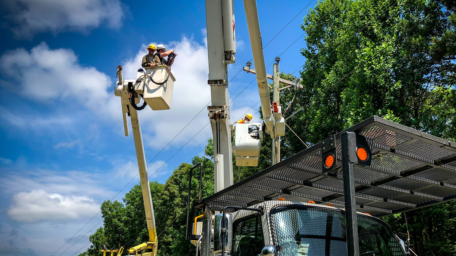 Men working on electrical wires for a utility company
