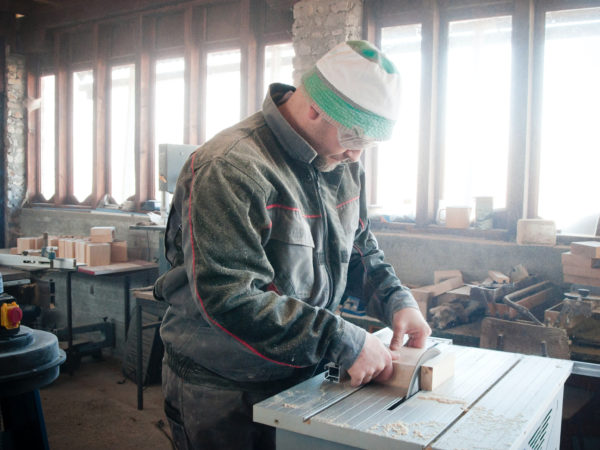 A man working on a small wooden project