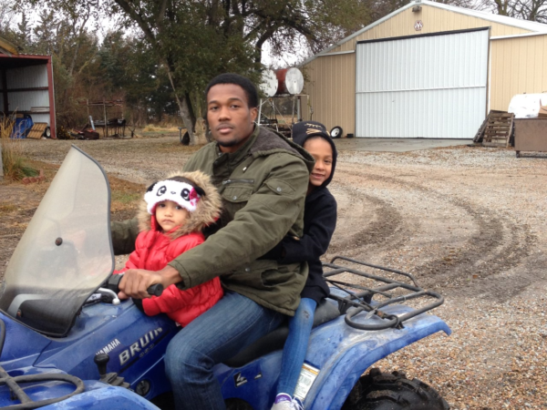 Orin and two children on a quad