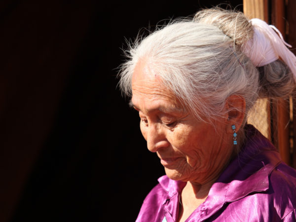 An elderly Navajo Nation woman sitting reflectively