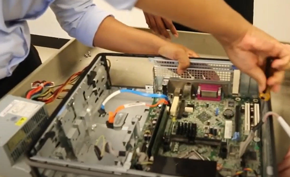 Hands working on the inside of a server
