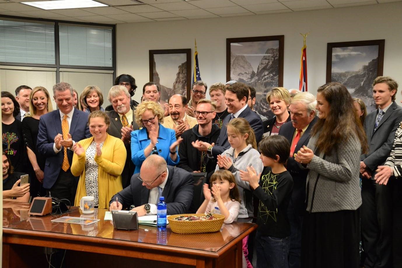 A large group of people watching legislation being signed