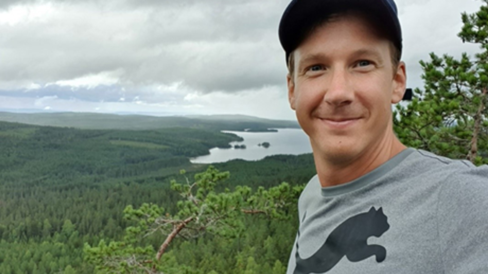 Björn Ahnell smiling at the top of a mountain