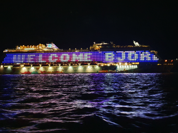 A cruise ship with giant lighted display that reads 