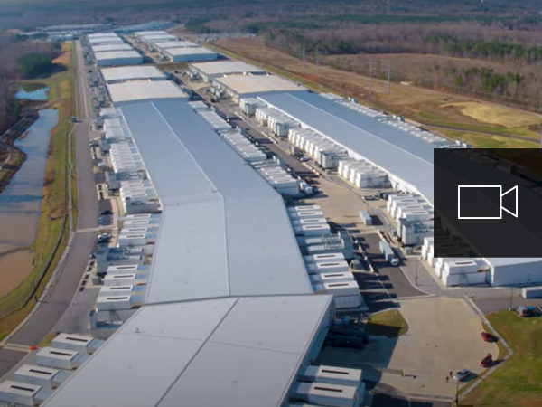 Letecký pohled na microsoftové centrum s překrytou ikonou videa
