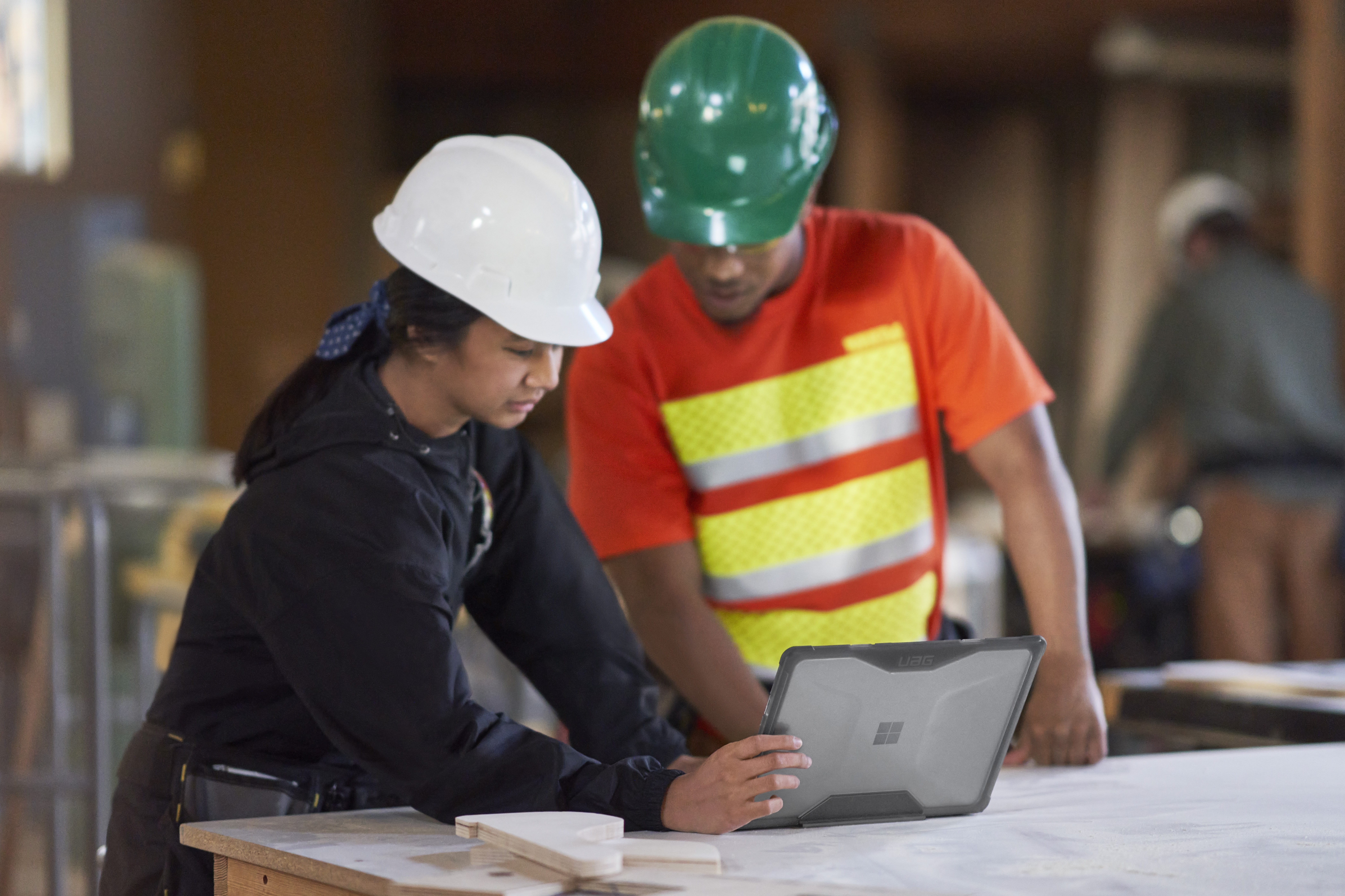 عمال البناء يخططون باستخدام الكمبيوتر المحمول