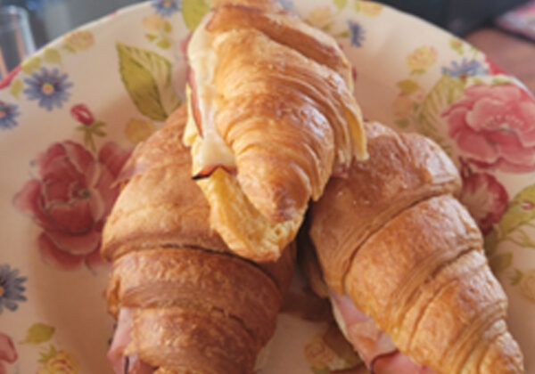 baked ham and cheese croissants on a plate