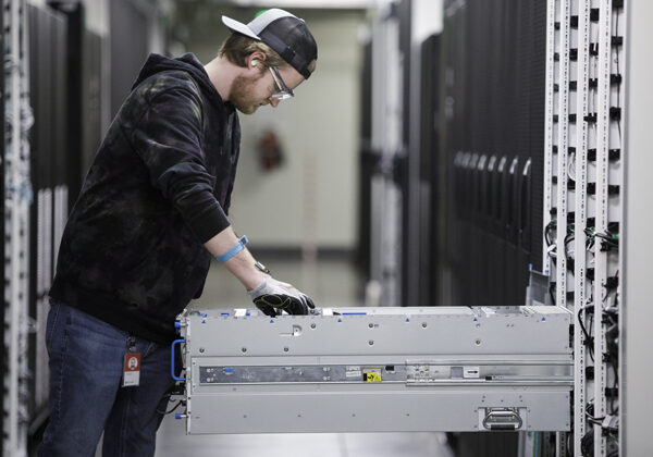 A young man working in a datacenter