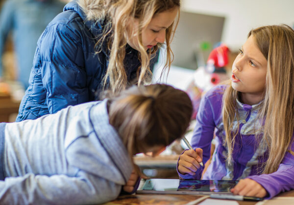 Children working on computers to create art