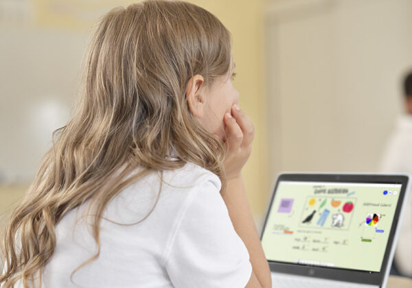 A child sitting at a computer learning how to code