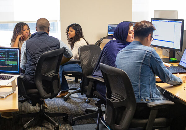 A group of young people learning on computers