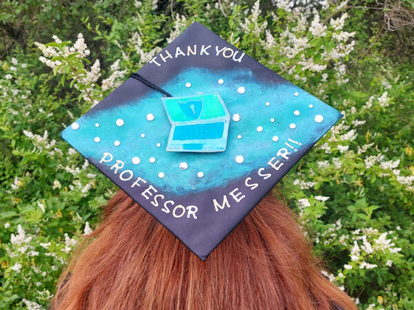 Kayla Blick, with a graduation hat that reads 