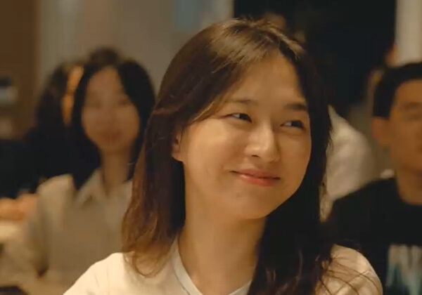 A young woman, smiling in a classroom in Korea