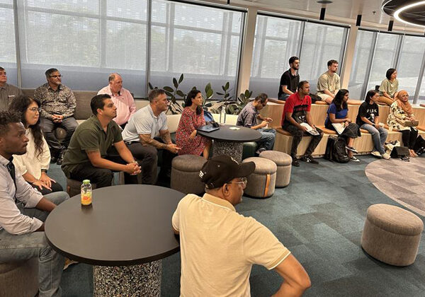 A large group of people sitting and listening to a speaker