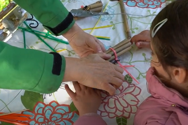 A young child learns how to create a habitat for bees