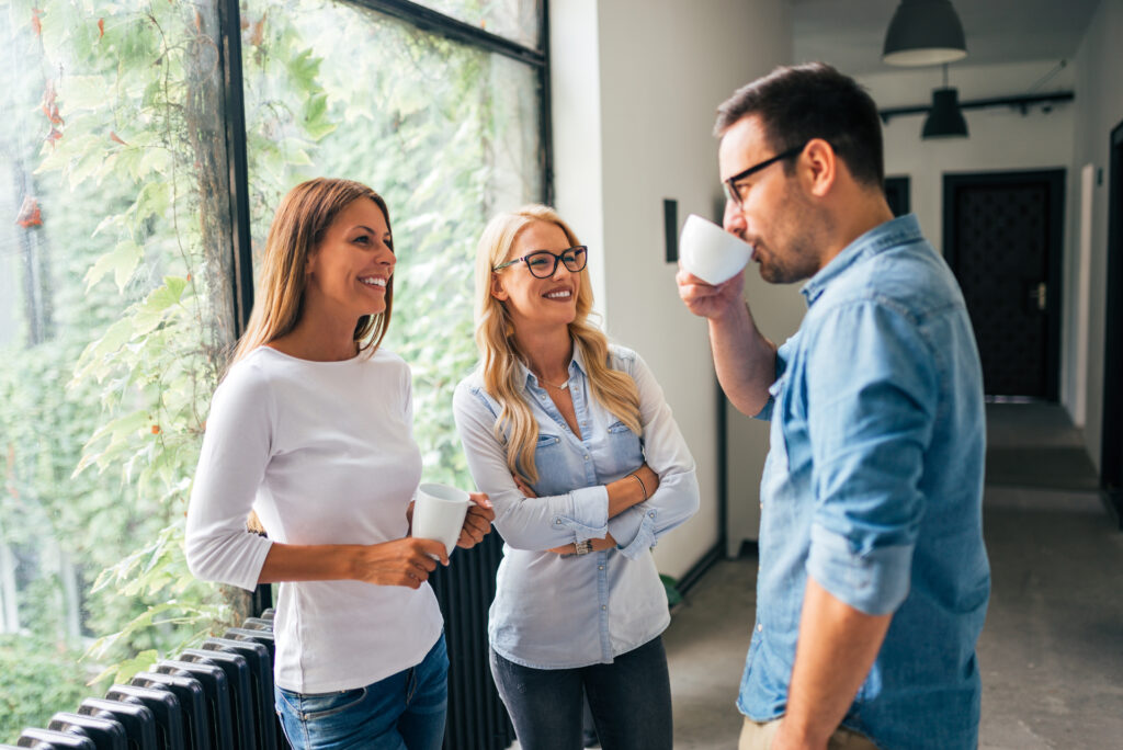 Three people meeting and drinking coffee