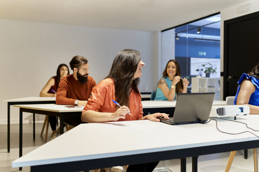 Adults in a classroom learning about computers