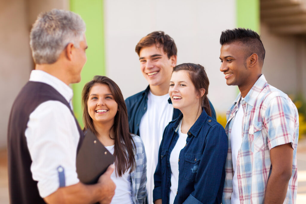 A mentor talking to high school students