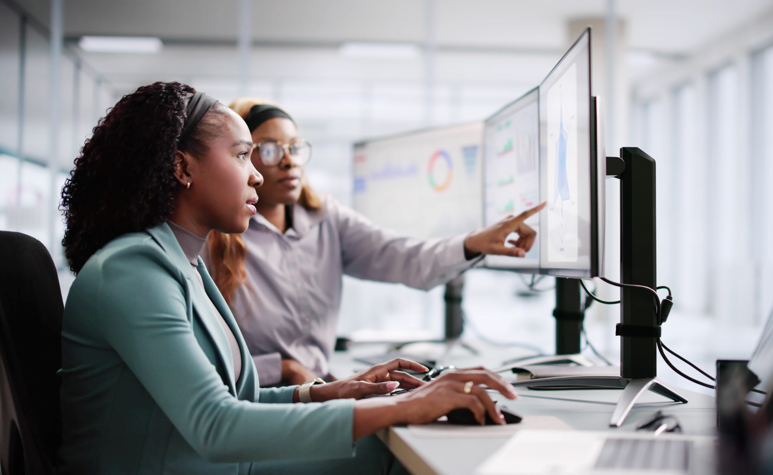 A young African American female learning on computers
